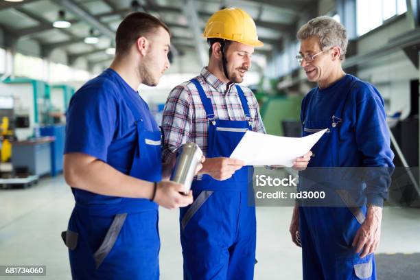 Team Of Engineers Having Discussion In Factory Stock Photo - Download Image Now - Craftsperson, Engineer, Factory