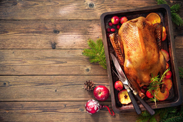 istock Christmas roast duck with apples and oranges on baking tray 681736532