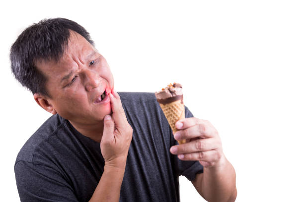 istock Matured man suffering intense toothache pain after biting ice cream 681744360