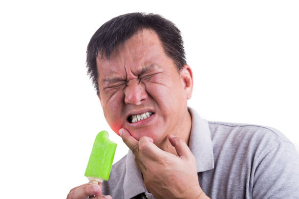 istock Matured man suffering intense toothache pain after biting ice cream 681744468