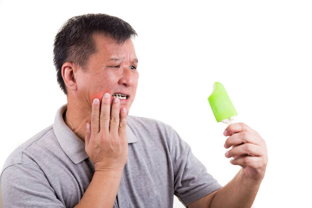 istock Matured man suffering intense toothache pain after biting ice cream 681744664
