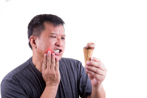 istock Matured man suffering intense toothache pain after biting ice cream 681744716