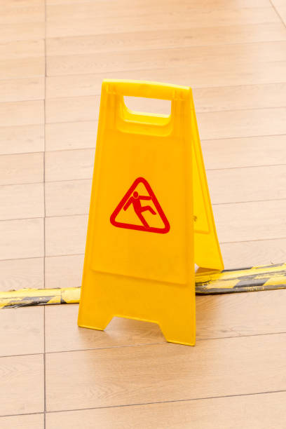 istock Slippery icon on yellow plastic warning sign alerts for hazard on floor, under construction concept. 681758516