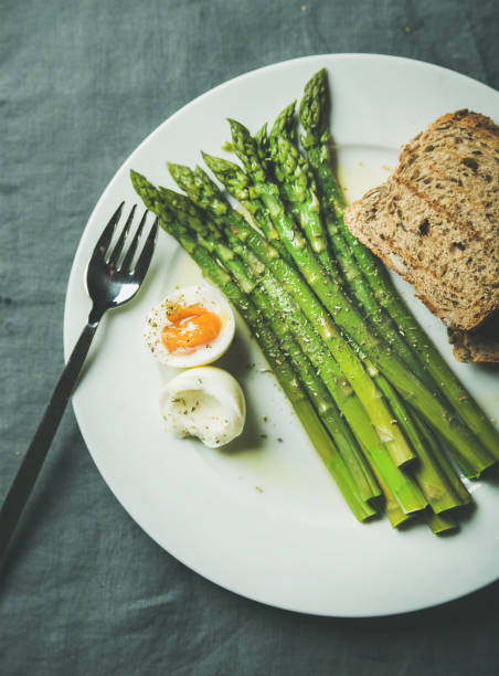 istock Cooked asparagus with soft-boiled egg, grilled bread and herbs 681759002