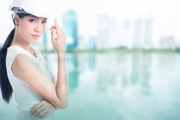 istock Female engineer with blur buildings background 681774556