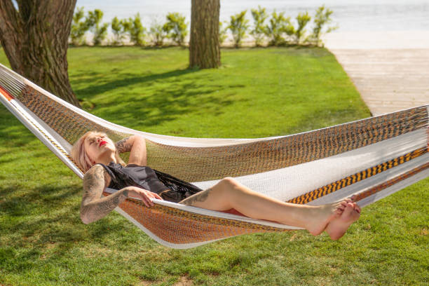 istock Young blonde woman resting on hammock 681778482