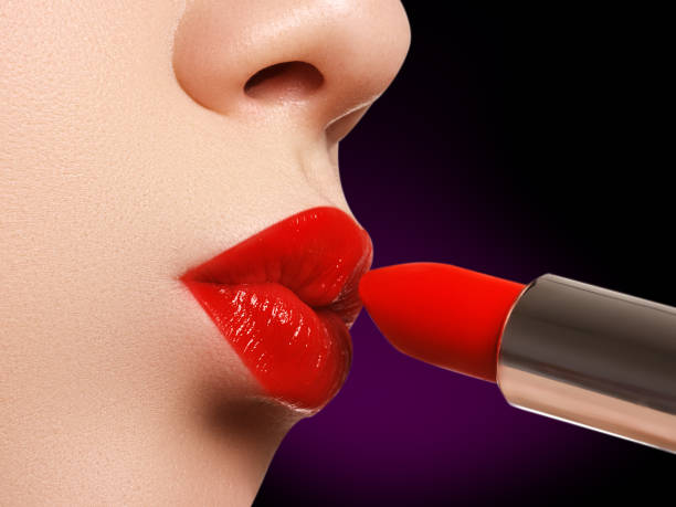 istock Extreme close up on model applying red lipstick. Makeup. Profess 681784548