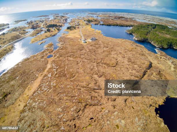 Fishing Village Around Rocky Terrain Covered With Grass Stock Photo - Download Image Now