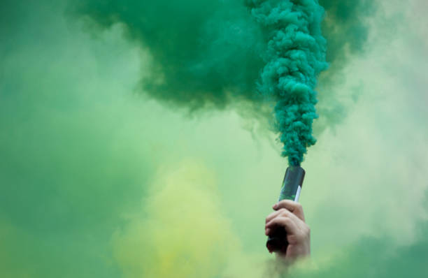 hand with color smoke bomb