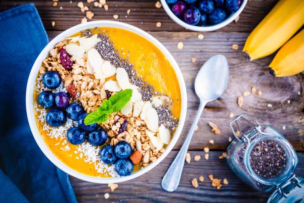 istock Mango smoothies bowl with blueberries, granola, chia seeds and almonds 681792278
