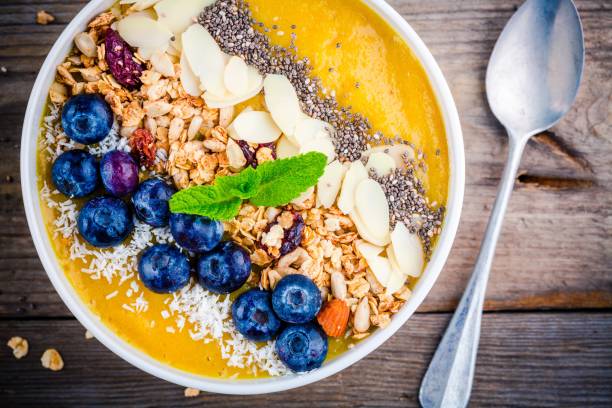 istock Tropical smoothies bowl with blueberries, granola, chia seeds and almonds 681792390