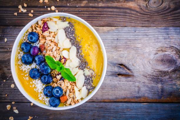 istock Mango smoothies bowl with blueberries, granola, chia seeds and almonds 681792456