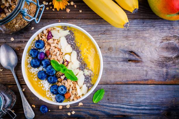 istock Mango smoothies bowl with blueberries, granola, chia seeds and almonds 681792622