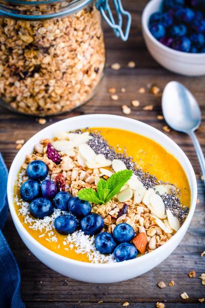 istock Tropical smoothies bowl with blueberries, granola, chia seeds and almonds 681792734