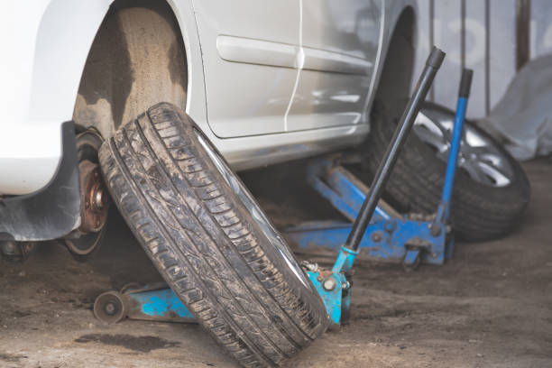 istock Car wheel tire replacement on tire jack 681799278
