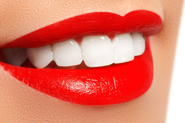 istock Close-up happy female smile with healthy white teeth, bright red lips make-up 681800468