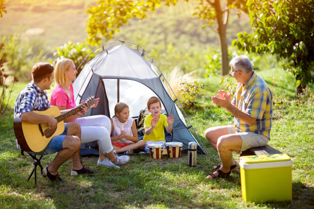 istock parent and children enjoying with guitar 681803678