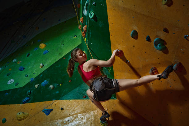 istock Female climber purposeful climbs up the indoor climbing wall 681803822