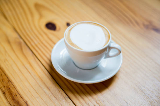 istock A cup of hot cappuccino in wood table 681807072