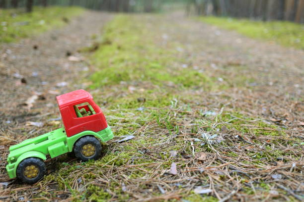 istock Toy truck on a forest road 681807662