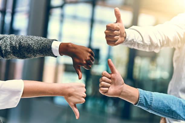 They've got a decision to make Cropped shot of a group of unrecognizable businesspeople gesturing thumbs up and down thumb down stock pictures, royalty-free photos & images