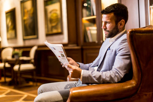 istock Modern businessman reading newspaper 681811486