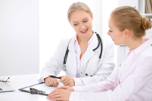 istock Doctor and  patient  sitting at the desk 681824372
