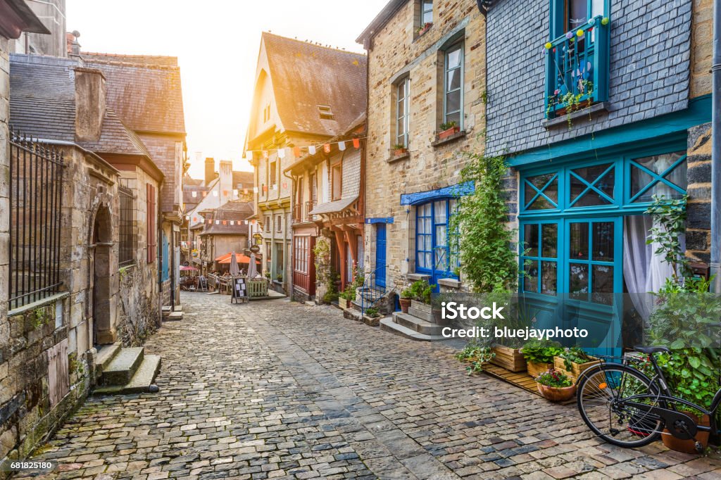 Charming street scene in an old town in Europe at sunset Panoramic view of a charming street scene in an old town in Europe in beautiful evening light at sunset with retro vintage Instagram style pastel toned filter and lens flare sunlight effect in summer France Stock Photo