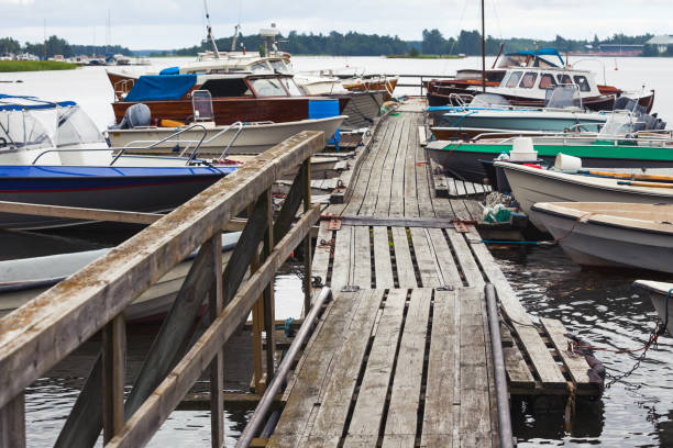 istock Old wooden floating pier with moored boats 681825194
