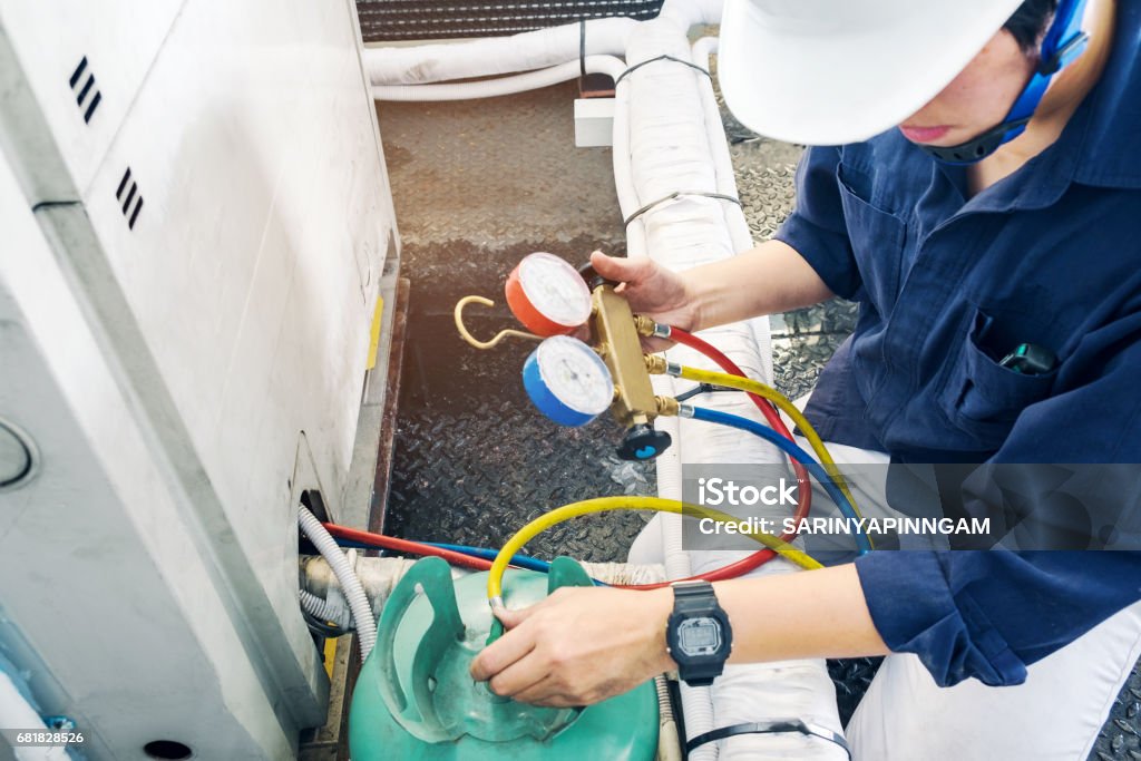 Technician is checking air conditioner Air Conditioner Stock Photo