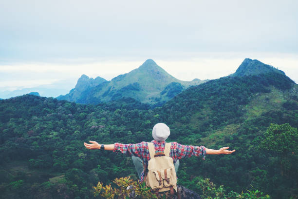 istock man sitting on mountain,adventure travel concept 681834488