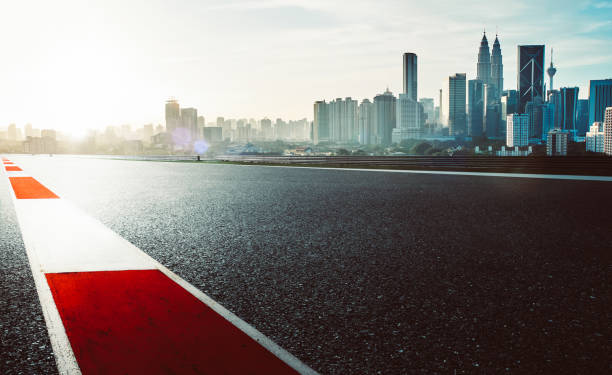 istock Racetrack with red and white safety sideline ,modern city background ,dramatic cloudy sky and vintage mood filter apply . 681835086