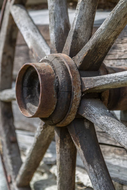 Ancient Wooden Wheel Close-Up The old wooden wheel otside the old workshop rusty old wagon detail stock pictures, royalty-free photos & images