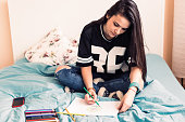 Girl drawing in coloring book