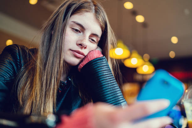 Bored girl in cafe texting