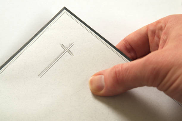 Condolences, hand holding an envelope, invitation for a funeral