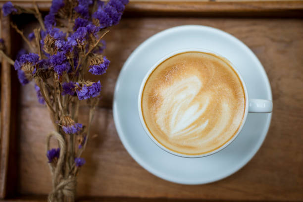 istock hot latte art on wood table background 681839522