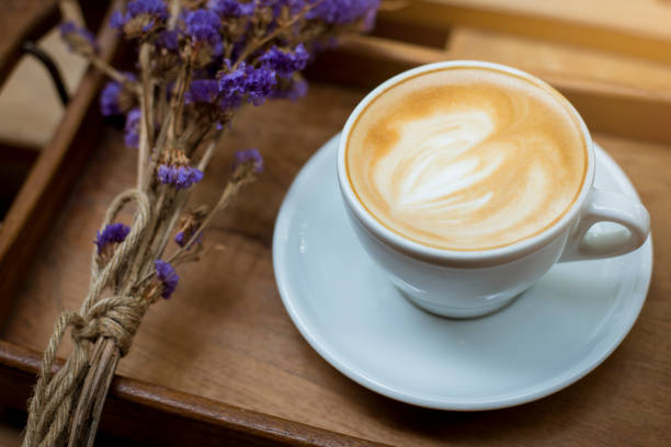 istock hot latte art on wood table background 681839686