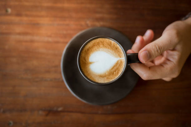 istock Hot latte art with  black glass on wooden table 681846754