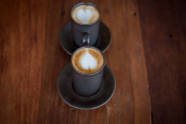 istock Hot latte art with  black glass on wooden table 681848718