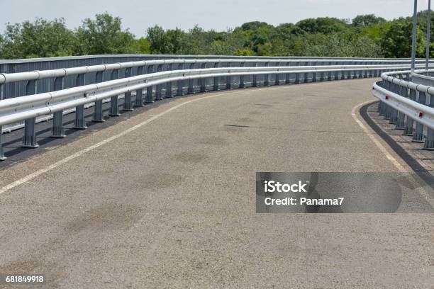 Modern Asphalt Road With Metal Fences And Walkway Closeup Stock Photo - Download Image Now