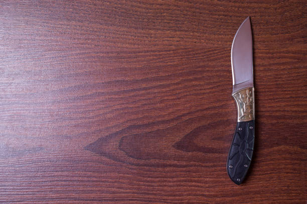 istock hunting knife on wooden background, copyspace 681853772