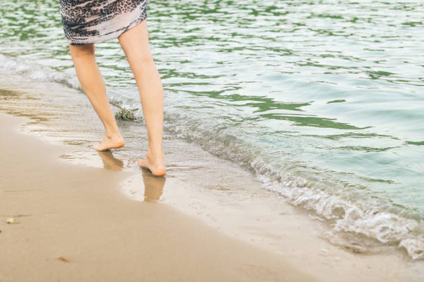 istock Touch of gentle waves on her feet 681861016