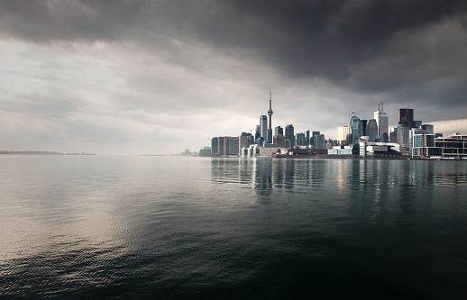 Toronto's CBD, seen across the water with a stormy, overcast sky.