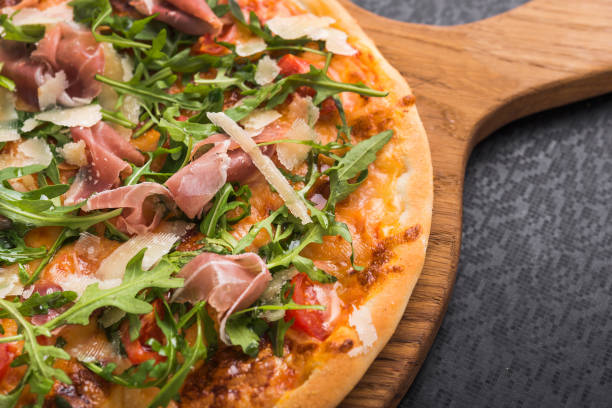 istock hot italian pizza with prosciutto and arugula 681867422