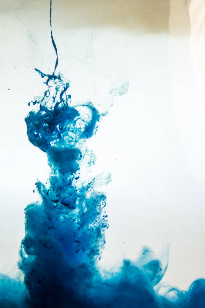istock blue ink in water isolated on white background 681881920