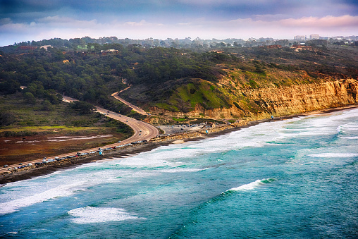Highway 101 along the southern California coastline as it reaches the cliffs of the famous Torrey Pines reserve in the La Jolla area of the City of San Diego.  This image was shot at an altitude of approximately 1000 feet over the Pacific Ocean during a helicopter photo flight.