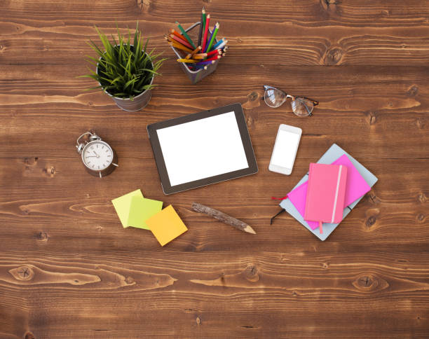 istock Tablet computer and office supplies on wooden background 681886808