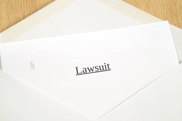 istock Lawsuit printed on white paper and envelope, wooden background 681889478