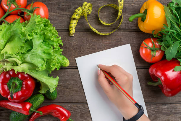 istock Sport and diet. Vegetables and centimeter. Peppers, tomatoes, salad on rustic background 681890820